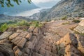 Mountainside view over Bay of Kotor and old stone steps leading down to a narrow winding path near the fortress Royalty Free Stock Photo