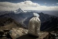 mountaintop, with view of the world below, and a plastic bottle trashbag in the foreground Royalty Free Stock Photo