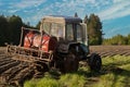 Mounted crop sprayer on boom added to wheeled tractor.