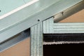 Mounted green plasterboards to an aluminum loft frame, visible black screws. Royalty Free Stock Photo