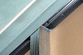 Mounted green plasterboards to an aluminum loft frame, visible black screws. Royalty Free Stock Photo