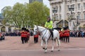 Mounted police officer leads marching Royal Guard soldiers