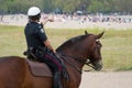 Mounted police officer points at crowded Woodbine Beach, Toronto, during stay-at-home order