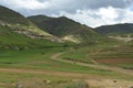 Mounted Sotho Man riding away into Lesotho Landscape Royalty Free Stock Photo