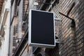 Mounted square sign on a wall with urban brick environment for advertising mockup. Template for logo, branding and corporate Royalty Free Stock Photo