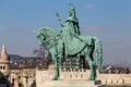 Mounted statue of Saint Stephen I, aka Szent Istvan kiraly - the first king of Hungary at typical white rounded tower of Royalty Free Stock Photo