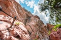 Mounted Wire and Steps Going Up a Via Ferrata Climbing Path on a Steep Stone Cliff Wall Royalty Free Stock Photo
