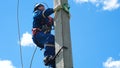 Mounter climbs up fast post with leg-irons unfastens mannequin at competition