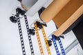 mounting manual support system for photo backdrops in modern studio. Rolls of colorful paper backgrounds for photo studio hang on