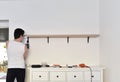 Mounting shelves on the wall. All necessary tools are placed on the chest of drawers