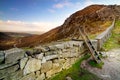 Mourn Wall with ladder on the Hares Gap overseeing beautiful valley with blue sky and white clouds Royalty Free Stock Photo