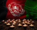 Mourning candles burning on Afghanistan national flag of background. Memorial weekend, patriot veterans day, National Day of