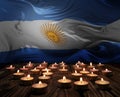 Mourning candles burning on Argentina national flag of background. Memorial weekend, patriot veterans day, National Day of Service