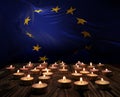 Mourning candles burning on The European Union national flag background. Memorial weekend, patriot veterans day, National Day of