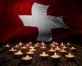 Mourning candles burning on Switzerland national flag of background. Memorial weekend, patriot veterans day, National Day of