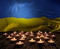 Mourning candles burning on Ukraine national flag of background. Memorial weekend, patriot veterans day, National Day of Service