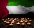 Mourning candles burning on United Arab Emirates flag of background. Memorial weekend, patriot veterans day, National Day of