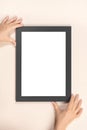 Mourning frame, hands hang on the wall black frame mockup. vertical, close-up Royalty Free Stock Photo