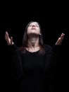 Mourning woman praying, with arms outstretched in worship to god Royalty Free Stock Photo