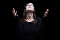 Mourning woman praying, with arms outstretched in worship to god Royalty Free Stock Photo