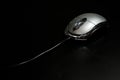 Mouse computer, wired, silver on a dark background Royalty Free Stock Photo