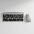 And mouse set on a white surface. The keyboard features a slim Royalty Free Stock Photo