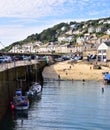 Mousehole`s Tiny Beach and Harbour Wall in Cornwall Royalty Free Stock Photo