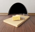 Mousetrap near mouse hole Royalty Free Stock Photo