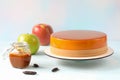 Mousse cake and its ingredients -caramel, green apple, red apple and tonka beans on the table Royalty Free Stock Photo