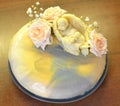 Bright mousse cake with mirror glaze. Decored by chocolate ange and roses in pastel colors