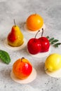 Mousse dessert in the shape of a pear fruit, orange fruit, apricot, lemon and cherry Royalty Free Stock Photo