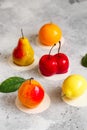 Mousse dessert in the shape of a pear fruit, orange fruit, apricot, lemon and cherry. Mousse cake Royalty Free Stock Photo