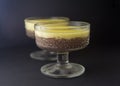 Mousse, souffle, pudding with vanilla and chocolate in glass black, dark background.