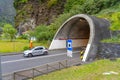 mouth of exit of the road tunnel of sÃ£o vicente with 2404 meters, light car in motion, Madeira island.