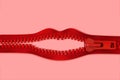 Mouth made of red zipper on pink background - Concept of violence against women and communication issues Royalty Free Stock Photo