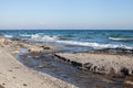 Mouth of Small River Running Into Wavy Sea Royalty Free Stock Photo