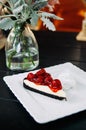 Mouth watering cherry cheesecake with pink rose Shot from top on