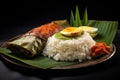 A mouth-watering combination of rice, meat, and egg on a plate, forming a satisfying and nutritious meal., Nasi Lemak wrapped in a