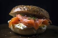 A close-up of a freshly baked bagel with dense texture and toppings, such as cream cheese and smoked salmon