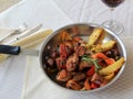 Mouth watering presentation of Chicken Scarpiello in stainless steel pan