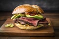 Mouth-watering roast beef sandwich with crispy bacon and creamy avocado on a toasted bagel Royalty Free Stock Photo