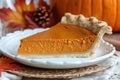 A mouth-watering slice of pumpkin pie placed neatly on a white plate, showcasing the delicious dessert, An elegant interpretation Royalty Free Stock Photo