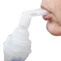 Mouthpiece of jet nebulizer in lips of patient