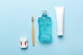 Mouthwash and other oral hygiene products on colored table top view with copy space. Flat lay. Dental hygiene. Oral care Royalty Free Stock Photo