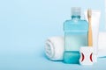 Mouthwash and other oral hygiene products on colored table top view with copy space. Flat lay. Dental hygiene. Oral care Royalty Free Stock Photo