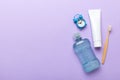 Mouthwash and other oral hygiene products on colored table top view with copy space. Flat lay. Dental hygiene. Oral care Royalty Free Stock Photo