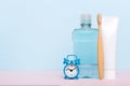 Mouthwash and other oral hygiene products on colored table top view with copy space. Flat lay. Dental hygiene. Oral care Royalty Free Stock Photo