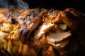 mouthwatering close-up of chicken shawarma meat roasting on a vertical spit, with charred edges and a golden-brown crust