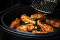 A mouthwatering close-up photo of juicy chicken grilling on a barbecue, ready to be savored, Hand Grilling Chicken Drumsticks In