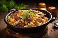 A mouthwatering dish of rice and meat, perfectly cooked and presented in a pan, ready to be enjoyed on a wooden table, Delicious